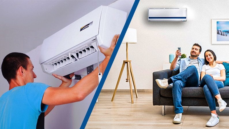 a man sitting on a couch and a man holding a white air conditioner